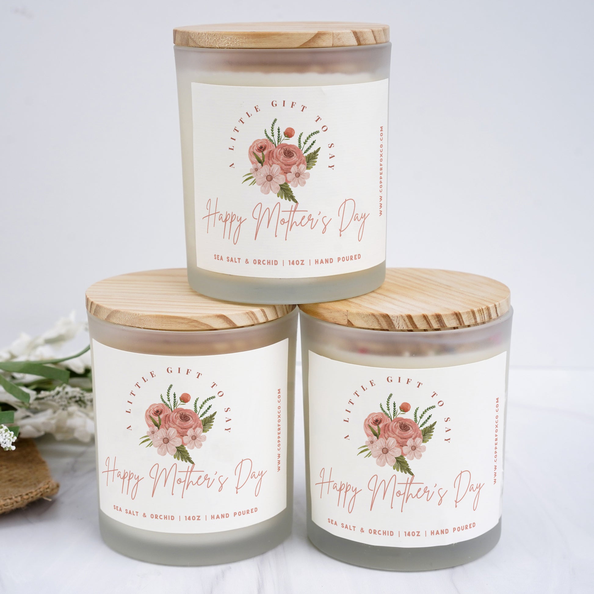 three jars of happy mother's day candles on a table