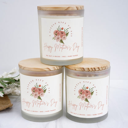 three jars of happy mother's day candles on a table