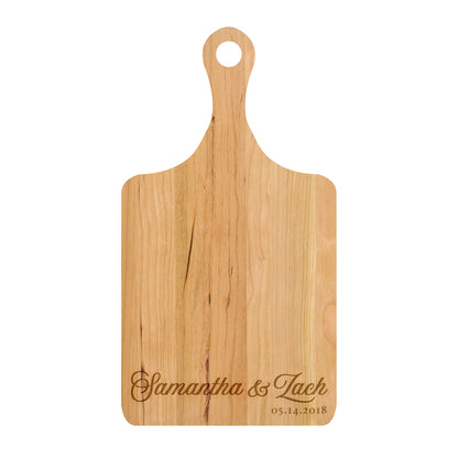 a wooden cutting board with a name on it