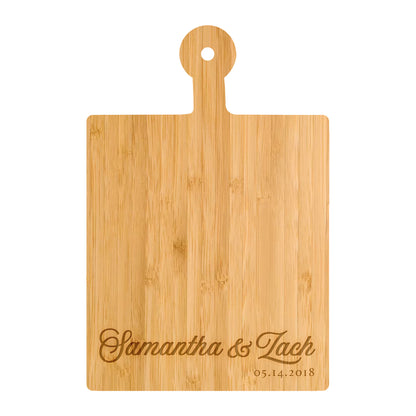 a cutting board with the name of a couple on it