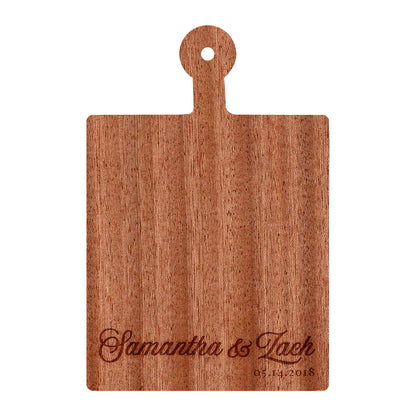 a wooden cutting board with a name on it